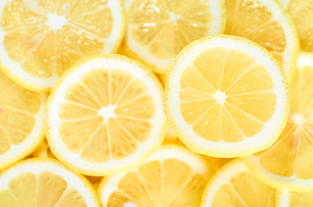 background of heap fresh yellow lemon slices. pattern for designの写真素材