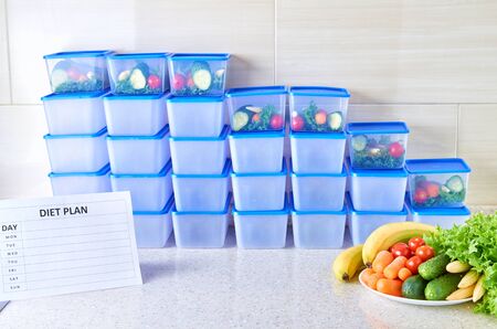 A meal plan for a week on a white table among set of plastic containers for food and food. Proper...