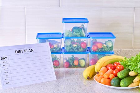 A meal plan for a week on a white table among set of plastic containers for food and food. Proper nutrition during the week.の写真素材