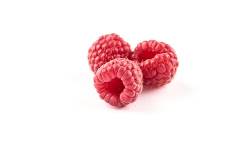 Three red raspberry berries isolated on white background.