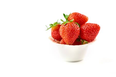 Strawberry berries on a saucer isolated on a white background.の写真素材