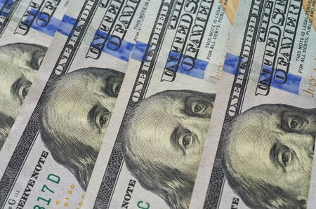Four hundred dollars in one hundred dollars bills lay on the table. Background of American paper money. Close up.の写真素材