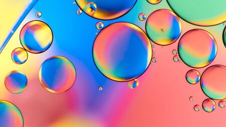Colorful abstract images of oil drops on water. Colored circles and waves as a concept of scientific discovery, space or molecular research.の写真素材