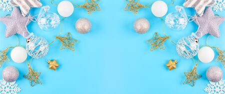 Christmas background with various Christmas decorations, colored garlands and beads, on a blue background. Christmas decorations. Christmas background. The view from the top. Space for text.の写真素材