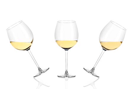 Three glasses of white wine half filled isolated on white background.の写真素材