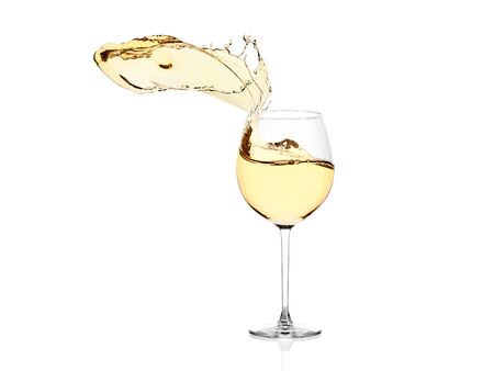 Glass of white wine isolated on white background. Wine spurts out of the glass.の写真素材