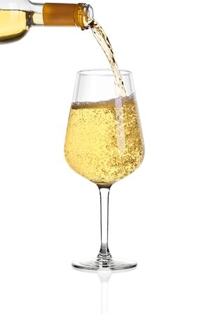 Glass of white wine isolated on white background. From above in glass is poured wine from the bottle.の写真素材