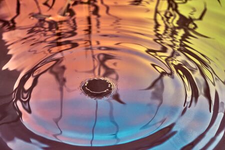 Raindrops fall on the surface of the water. The circles from the raindrops on the water surface....
