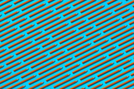 Orange pencils with hard shadows on a light blue background. Abstract background.