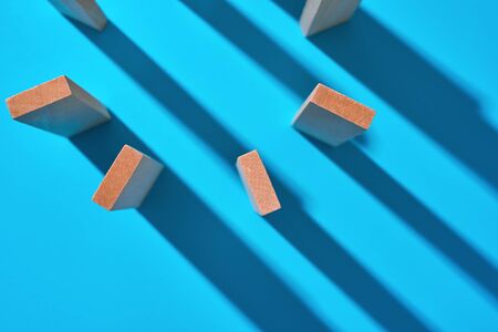 Wooden planks on a light blue background with hard shadows. Abstract background.