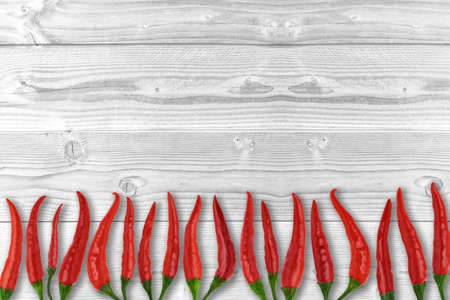 Pods spicy red chili peppers on white boards