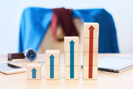 Business concept of growth, increase in revenue or value. The cubes on the table of the businessman...