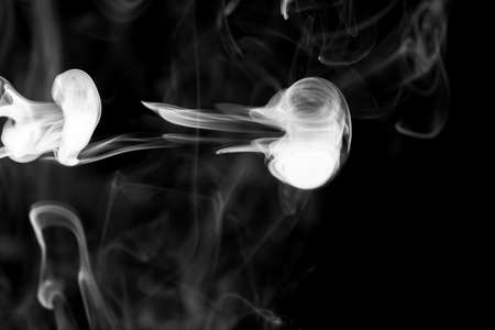 Clouds of white smoke on a black background, movement of smoke on a black background, clouds of...