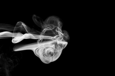 Clouds of white smoke on a black background, movement of smoke on a black background, clouds of smoke in the shape of a jellyfish, smoky background, abstract smokeの写真素材
