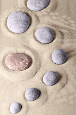 Round stones on smooth sand in the rock garden, for relaxation and spiritual harmony. Zen garden of meditation, relaxation, restoration of balance and harmony of spirituality, relaxationの写真素材