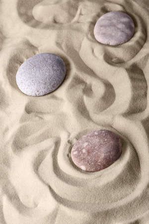 Smooth lines on the sand and round stones in the rock garden, for relaxation and spiritual harmony. Zen garden of meditation, relaxation, restoration of balance and harmony of spirituality, relaxationの写真素材