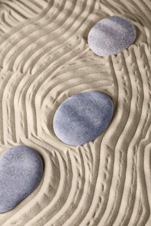 Smooth lines on the sand and round stones in the rock garden, for relaxation and spiritual harmony....