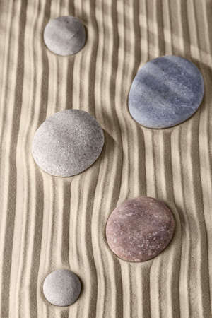 Smooth lines on the sand and round stones in the rock garden, for relaxation and spiritual harmony. Zen garden of meditation, relaxation, restoration of balance and harmony of spirituality, relaxationの写真素材