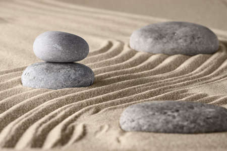 Smooth lines on the sand and round stones in the rock garden, for relaxation and spiritual harmony. Zen garden of meditation, relaxation, restoration of balance and harmony of spirituality, relaxationの写真素材