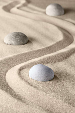 Smooth lines on the sand and round stones in the rock garden, for relaxation and spiritual harmony. Zen garden of meditation, relaxation, restoration of balance and harmony of spirituality, relaxationの写真素材