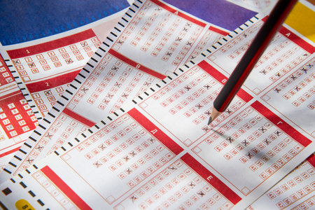 Filled lottery tickets and pencil, close-up, playing lottery or bingo have a chance to win the jackpot. Free space for text.の写真素材