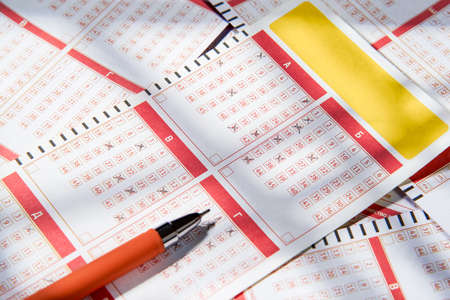 Filled lottery tickets and pencil, close-up, playing lottery or bingo have a chance to win the jackpot. Free space for text.の写真素材