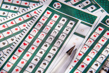 Filled lottery tickets and pencil, close-up, playing lottery or bingo have a chance to win the jackpot. Free space for text.の写真素材