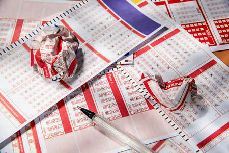 Crumpled lottery tickets lie on the filled lottery tickets, close-up, playing lottery or bingo has a chance to win the jackpot. Free space for text.の写真素材