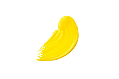 Yellow acrylic paint brush stroke isolated on a white background. Watercolour or oil yellow brushstroke on a white background.の写真素材