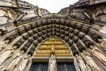 The main archway to the entrance to Cologne cathedral taken looking straight up with Mary at the center.の写真素材