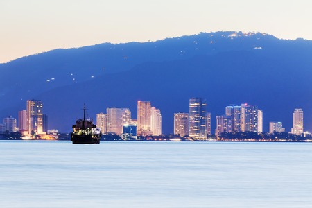 George Town City high rise building view with mountain and sea, Penang Malaysiaの写真素材