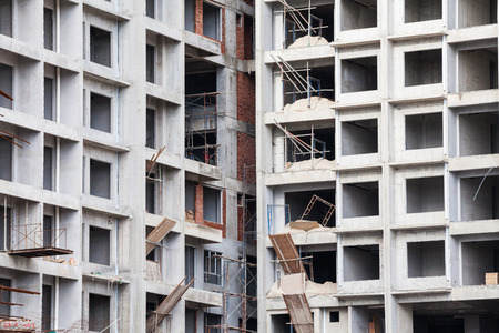 Construction site view of crane, lift, metal beam, brick, metal ladder and concrete