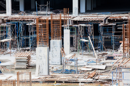 Construction site view of crane, lift, metal beam, brick, metal ladder and concreteの写真素材