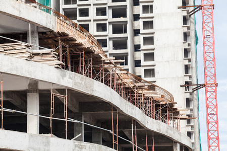 Construction site view of crane, lift, metal beam, brick, metal ladder and concrete