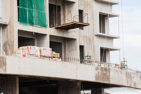 Construction site view of crane, lift, metal beam, brick, metal ladder and concreteの写真素材