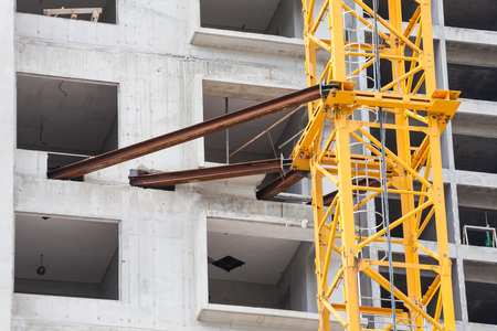 Construction site view of crane, lift, metal beam, brick, metal ladder and concreteの写真素材