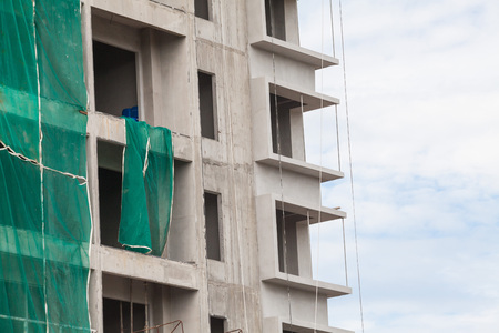 Construction site view of crane, lift, metal beam, brick, metal ladder and concreteの写真素材