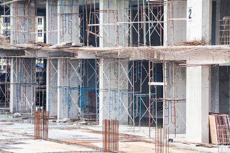 Construction site view of crane, lift, metal beam, brick, metal ladder and concreteの写真素材