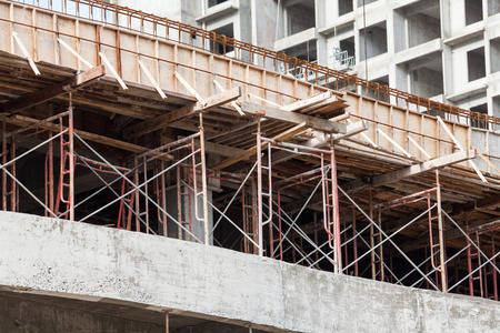 Construction site view of crane, lift, metal beam, brick, metal ladder and concrete