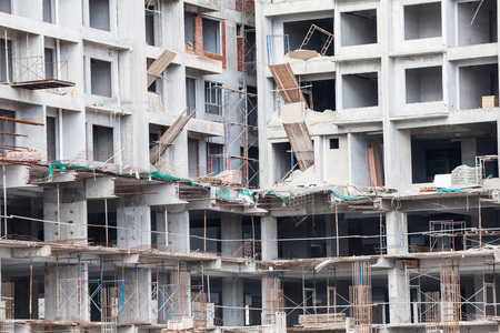 Construction site view of crane, lift, metal beam, brick, metal ladder and concreteの写真素材