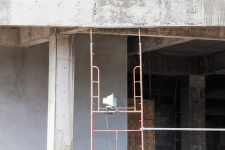Construction site view of crane, lift, metal beam, brick, metal ladder and concreteの写真素材