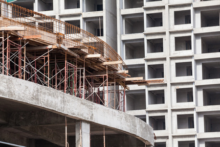 Construction site view of crane, lift, metal beam, brick, metal ladder and concrete
