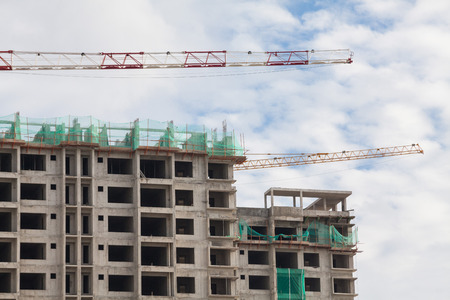 Construction site view of crane, lift, metal beam, brick, metal ladder and concrete