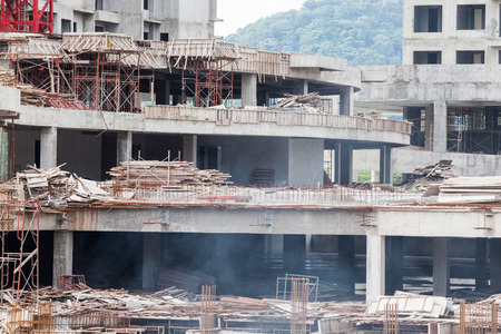 Construction site view of crane, lift, metal beam, brick, metal ladder and concreteの写真素材