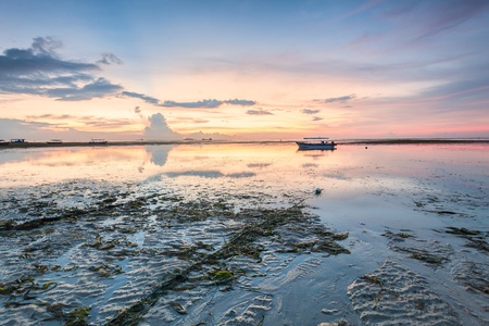 Holiday in Bali, Indonesia - Reflection Sunrise in Tanjong Benoa with boatの写真素材