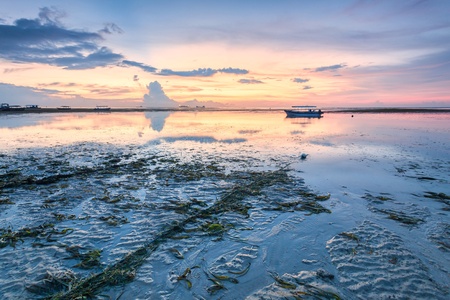 Holiday in Bali, Indonesia - Reflection Sunrise in Tanjong Benoa with boatの写真素材