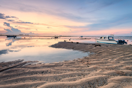 Holiday in Bali, Indonesia - Reflection Sunrise in Tanjong Benoa with boatの写真素材