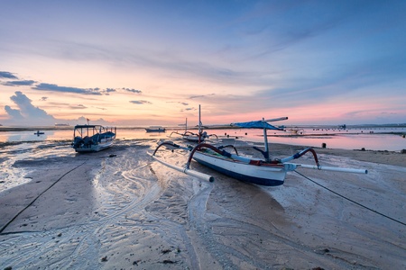 Holiday in Bali, Indonesia - Reflection Sunrise in Tanjong Benoa with boatの写真素材
