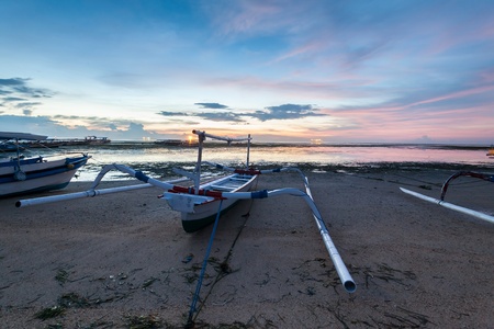 Holiday in Bali, Indonesia - Reflection Sunrise in Tanjong Benoa with boatの写真素材