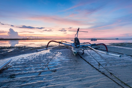 Holiday in Bali, Indonesia - Reflection Sunrise in Tanjong Benoa with boatの写真素材